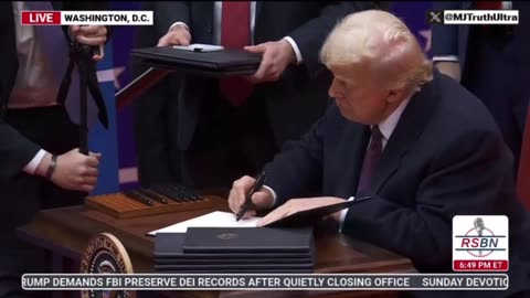 Donald Trump signs and reads aloud the Executive Orders