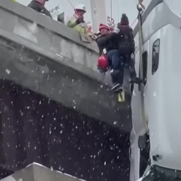 DRAMATIC RESCUE: First responders pull truck driver to safety after 18-wheeler skid off snow-covered highway