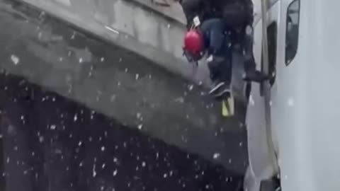 DRAMATIC RESCUE: First responders pull truck driver to safety after 18-wheeler skid off snow-covered highway