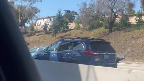 Guy on Car Roof in LA Traffic