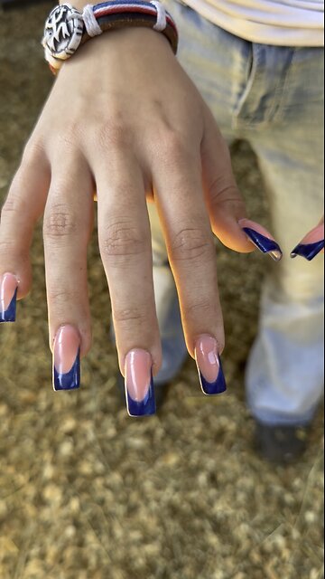Milking goat with long fake nails
