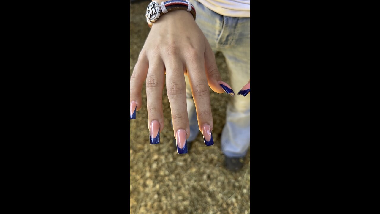 Milking goat with long fake nails