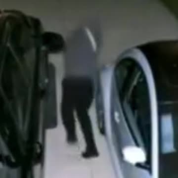 Easily Spooked! Man Prowling Around Vehicle Gets Startled by Light, Scurries Away