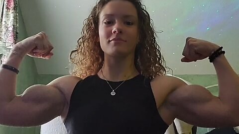 Beautiful muscular woman flexing muscles