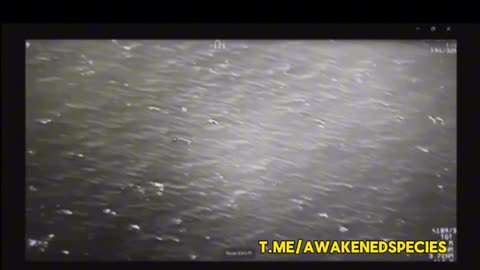 Military surveillance video shows a UFO splitting a Hellfire missile in mid air.