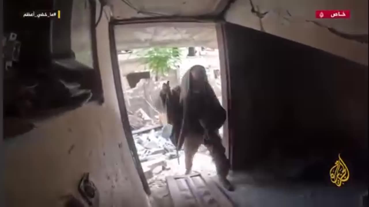 Yahya Sinwar walking between houses and near the Zionist occupation forces