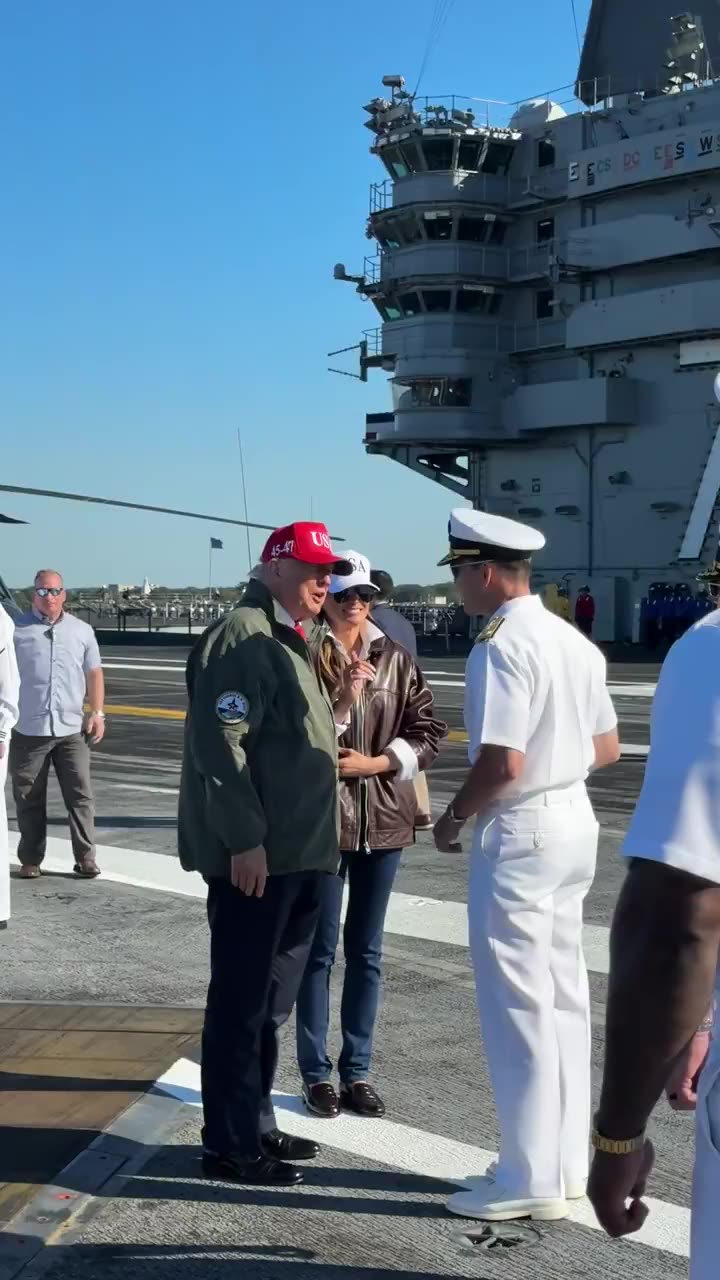 President Trump and theFirst Lady walk through a cordon of U.S. Navy Sailors