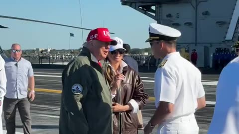 President Trump and theFirst Lady walk through a cordon of U.S. Navy Sailors
