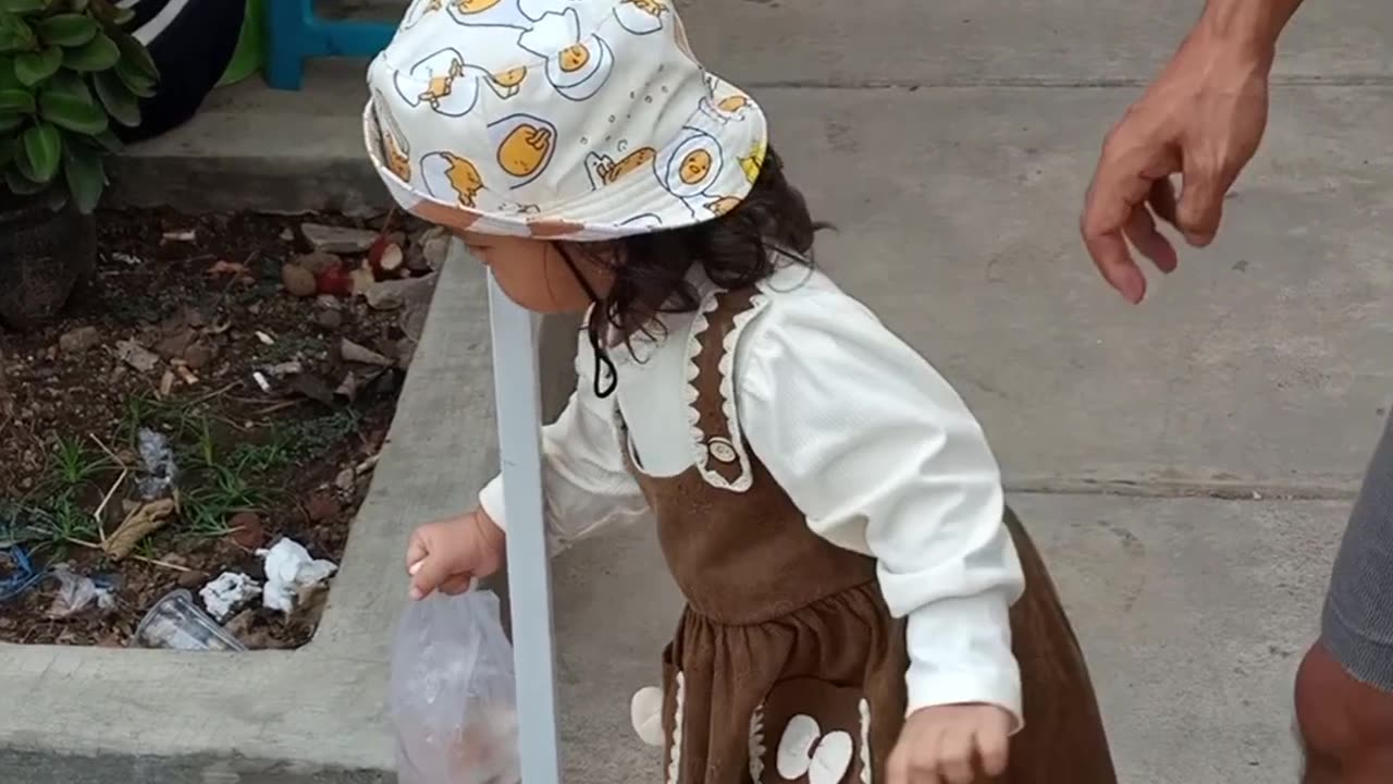 Toddler Carefully Moves Fish Around A Pole