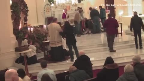 Crazed man with long hair attacks Catholic priest Father David Gaines in