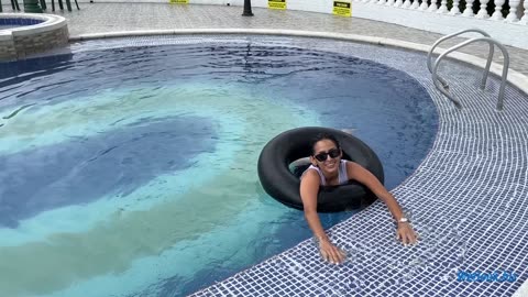 Wetlook girl swim in the pool, fully dressed