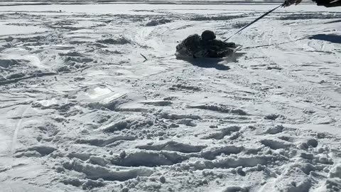 Snow revelers craft makeshift ride with an excavator and cart top