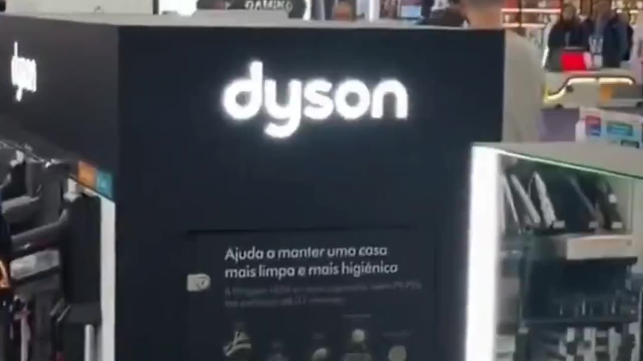 A man with a hammer destroys numerous televisions and computers in a shopping