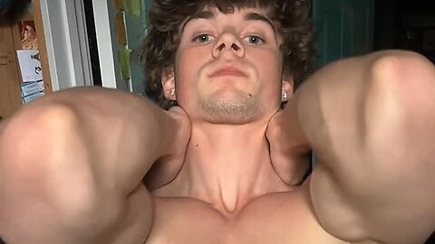 Teen boy flexing muscles