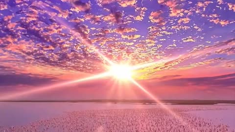 Sunset on Lake Nakuru in Kenya, with pink flamingos in the background.