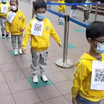 Chinese Children lining up for State Mandated vax, with QR Code for their Vax Passport