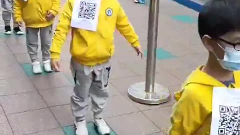Chinese Children lining up for State Mandated vax, with QR Code for their Vax Passport