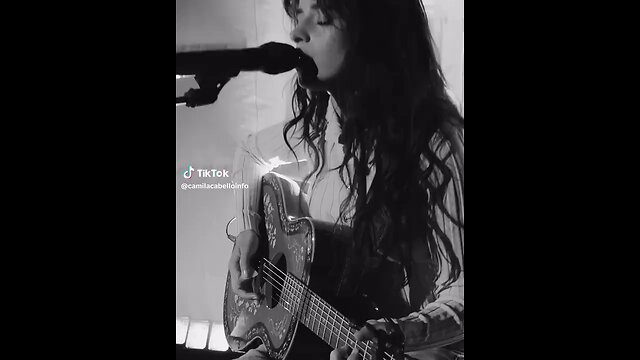 Camila Cabello playing on the guitar