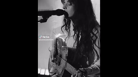 Camila Cabello playing on the guitar