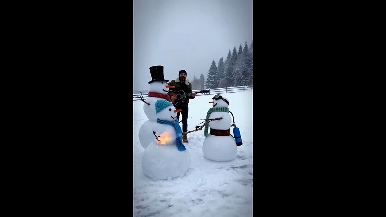 Snowman using a flamethrower to melt 2 snowmen while Joseph Martelli sings