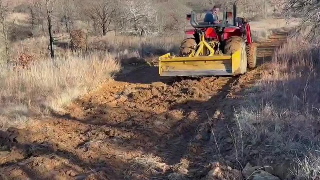 Red road ruts 2 : Box blading in the mud.