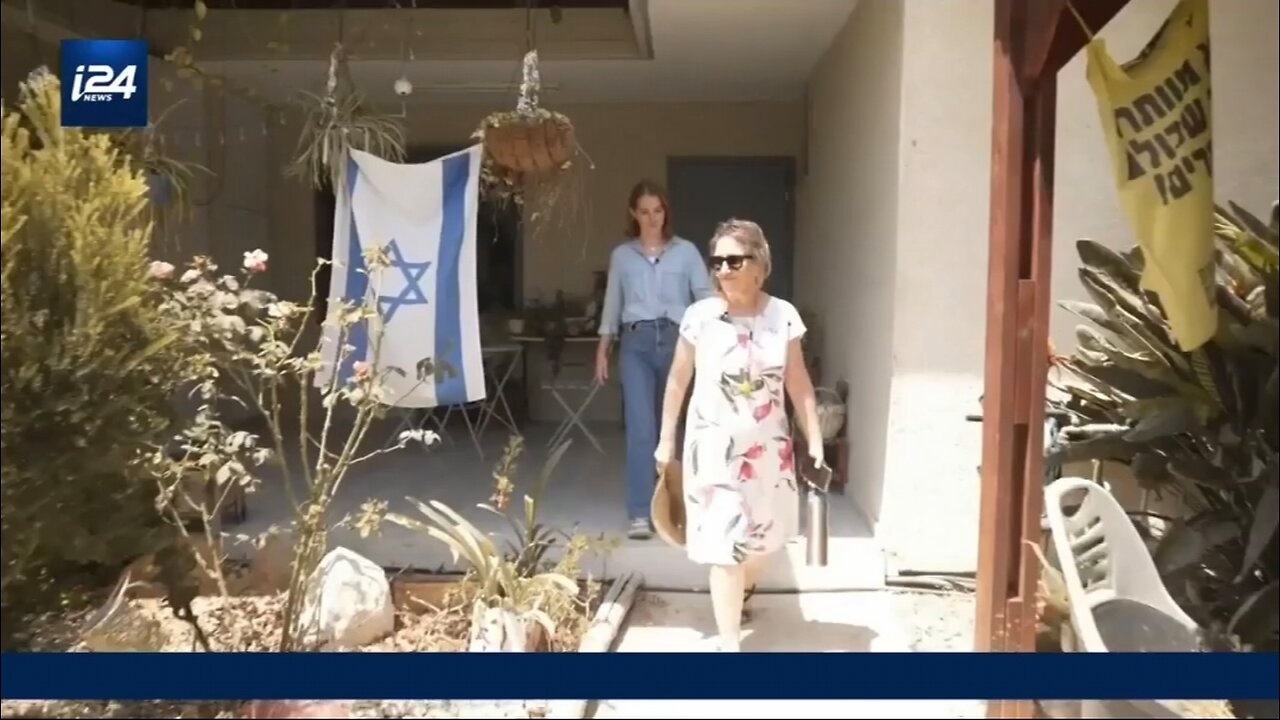 TwOo years after October 7, Adele Raemer Walks through the front dor of her rebuilt home in КіЬьиtZ.