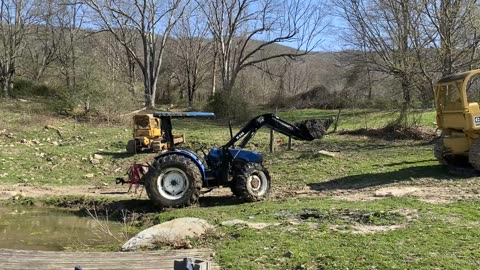 Pulling the Tractor out of the pond with Dozers