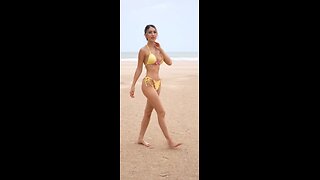 Beutiful brunette in yellow bikini on the beach