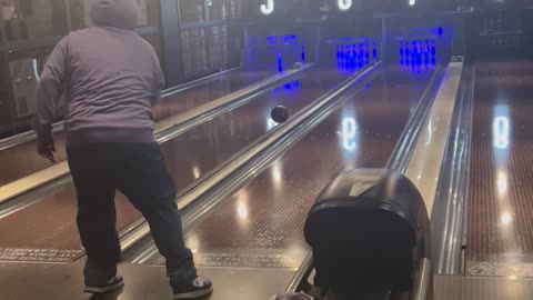 Player Throws Bowling Ball Across Lanes