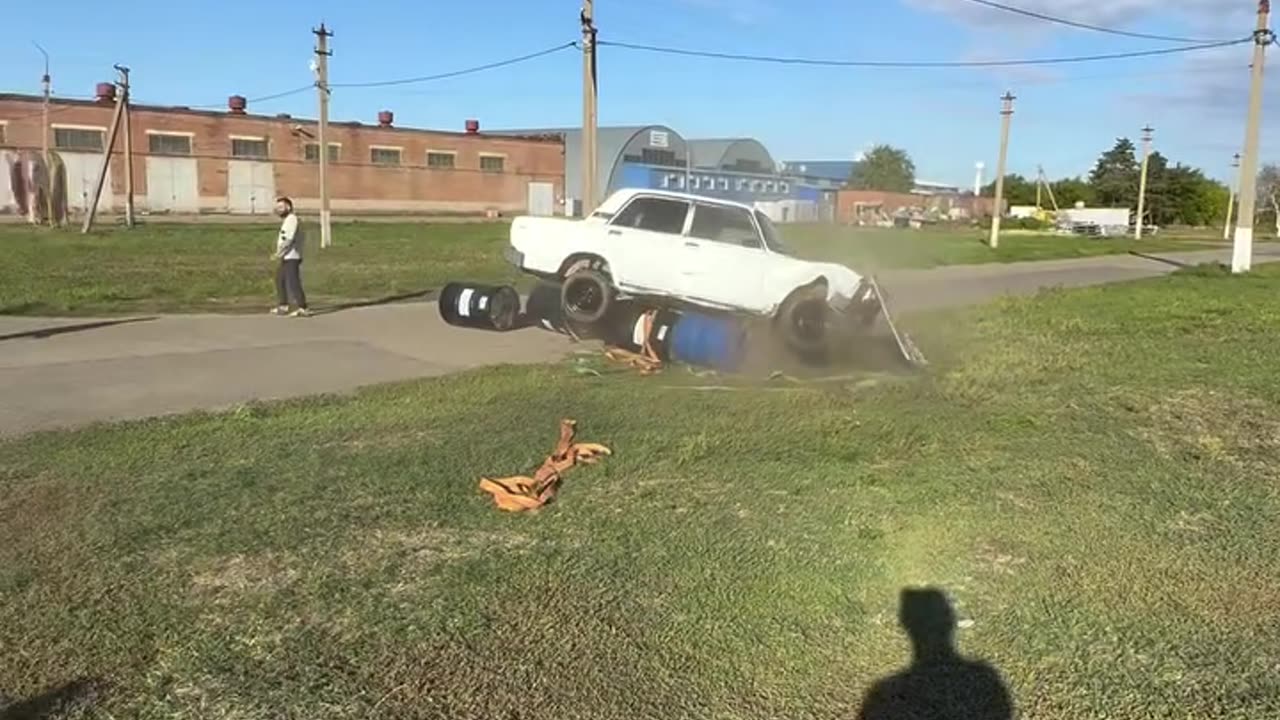Car's Barrel Tower Topples Over