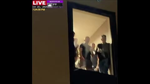 ICE Agents look down upon protesters outside of Minnesota hotel