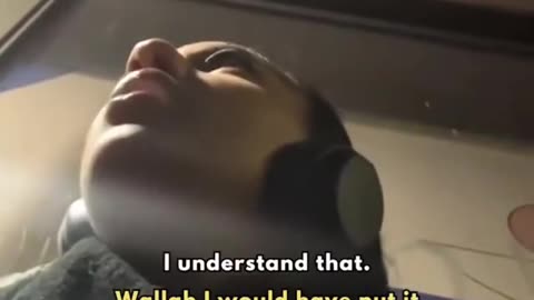 A woman is sat at a bus stop in London