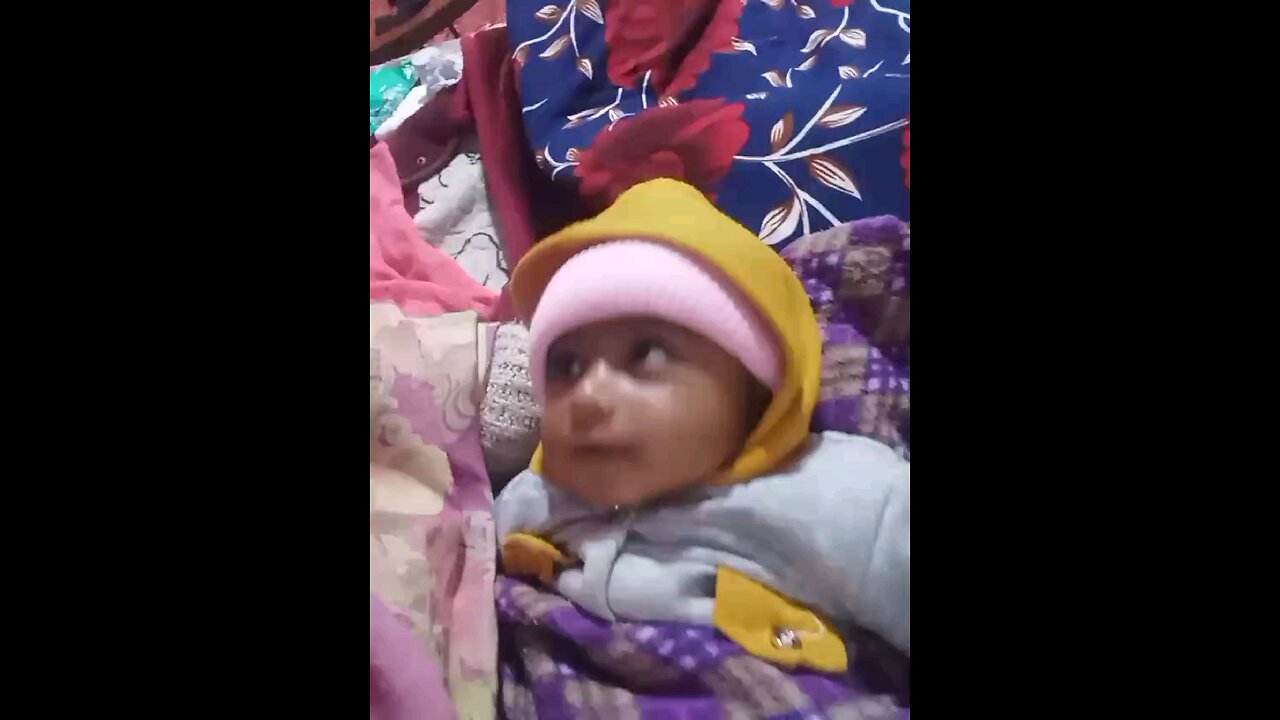 baby is smiling while talking to mom