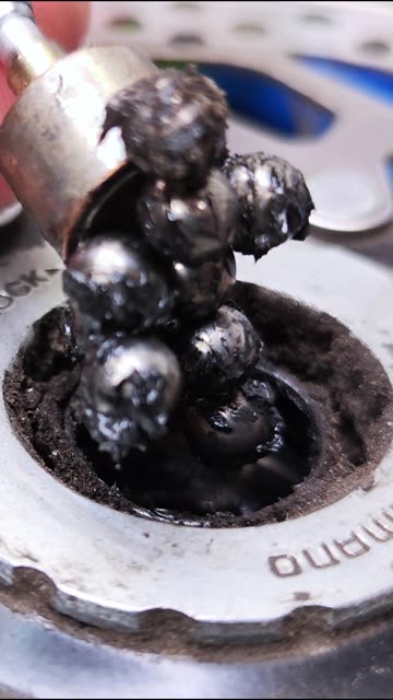 Disassembling a bicycle wheel hub to check the condition of the bearing balls.