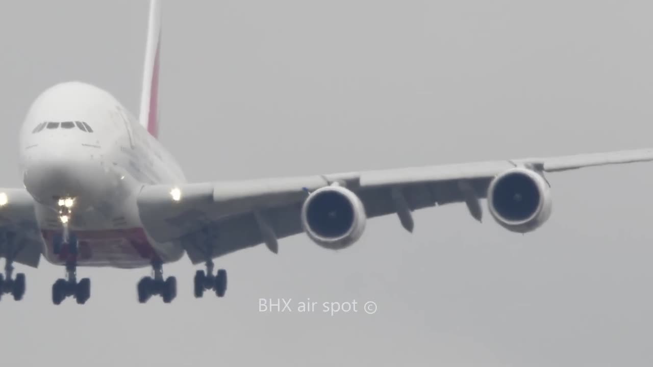 A small balloon crosses the approach path of the giant Emirates Airbus A380-800