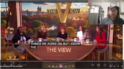 Whoopi is wearing what on her shirt