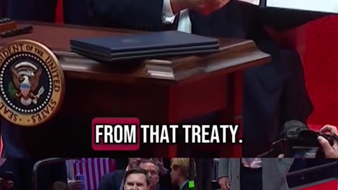 President Trump signs a series of Day 1 executive orders before a crowd