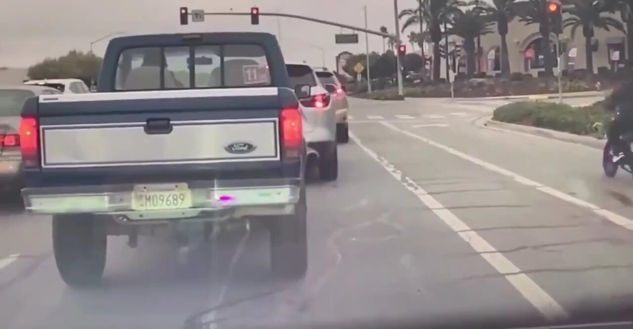 Shocking Phoenix Rain Crash: Motorcyclist Runs Red Light, Bike Erupts in Flames – Dashcam Footage