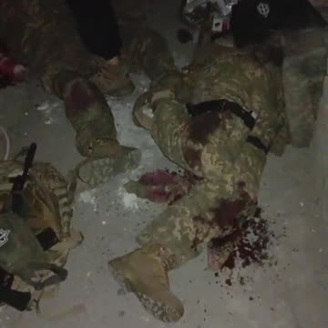 finishes off his own wounded Ukrainian Armed Forces soldier.