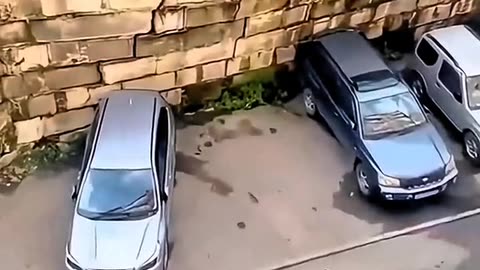 LANDSLIDE COVERS SEVERAL CARS IN A PARKING LOT