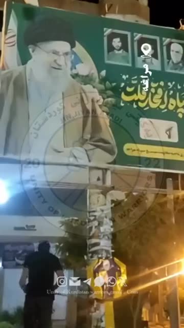 An Iranian burns a portrait of the Supreme Leader of the Islamic Revolution.