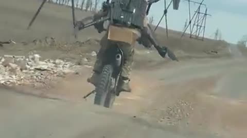 Russian Soldier Rides Motorcycle with Captured Ukrainian Quadcopter — One Prop Still Spinning 😂