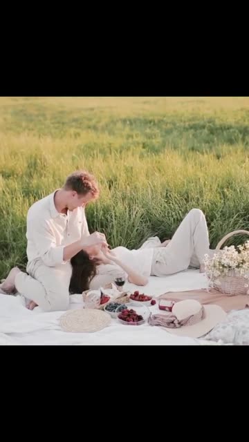 A Passionate Couple Having a Picnic In A Grass Field
