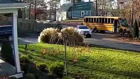 S A RED LIGHT AND THE SCHOOL BUS IS PICKING UP THE KID