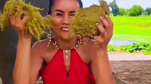 This girl catches elephant droppings