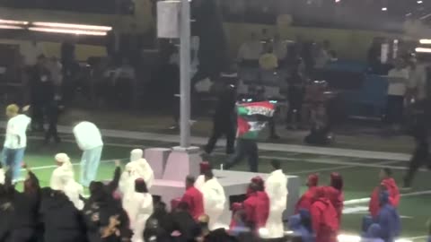 Super Bowl 2025 halftime show performer waves Palestinian, Sudanese flags, apprehended by security