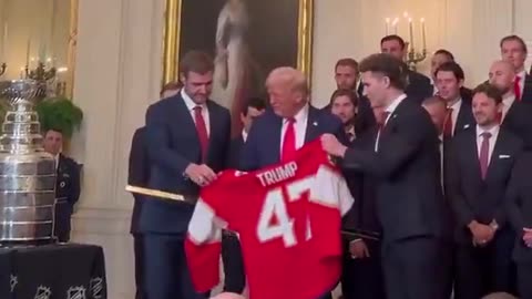 🚨 President Trump was just gifted a GOLD HOCKEY STICK and a Trump Jersey