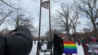 Leftist anti-Trump protesters set up a guillotine in front of an LGBTQ flag in