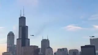 US military BLACKHAWK helicopters are flying over the city of Chicago