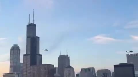 US military BLACKHAWK helicopters are flying over the city of Chicago